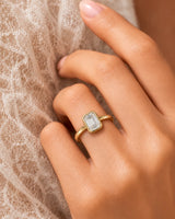 Golden Horizon natural emerald cut diamond bezel engagement ring worn on hand in rose gold | SARATTI