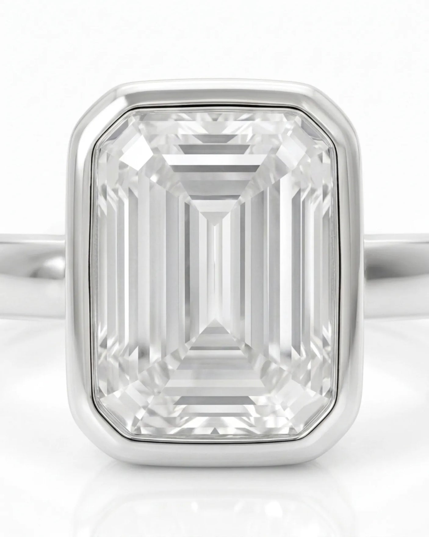 Natural emerald cut diamond full bezel ring in white gold close-up | SARATTI