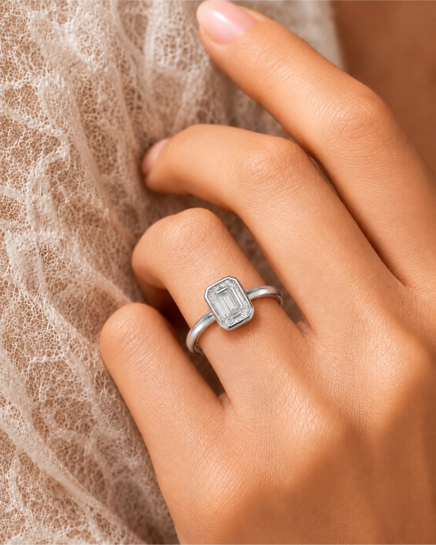 Golden Horizon natural emerald cut diamond bezel engagement ring worn on hand in yellow gold | SARATTI