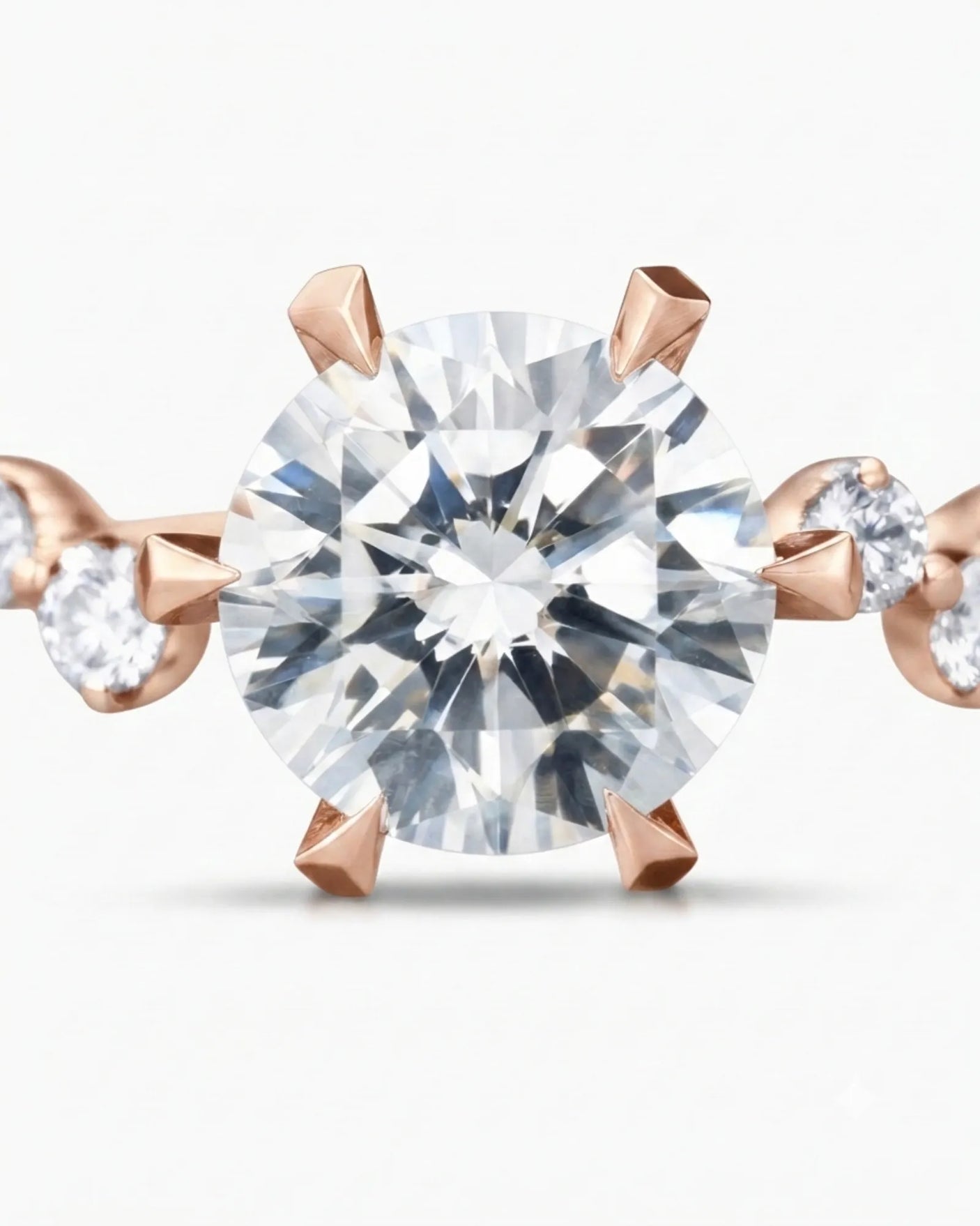 Joan 1 carat round natural diamond six-prong engagement ring in 18K rose gold, macro detail of graduated round brilliant diamond side stones | SARATTI
