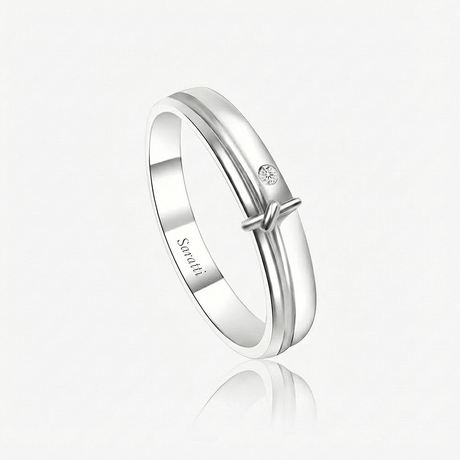 The Love Note Diamond Solitaire Band in 18K white gold with 0.03ct bezel-set round diamond knot detail | SARATTI