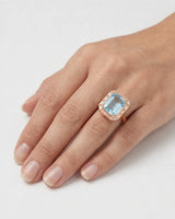 Lumière Octave emerald-cut Aquamarine baguette diamond halo ring setting in rose gold, worn on hand | SARATTI
