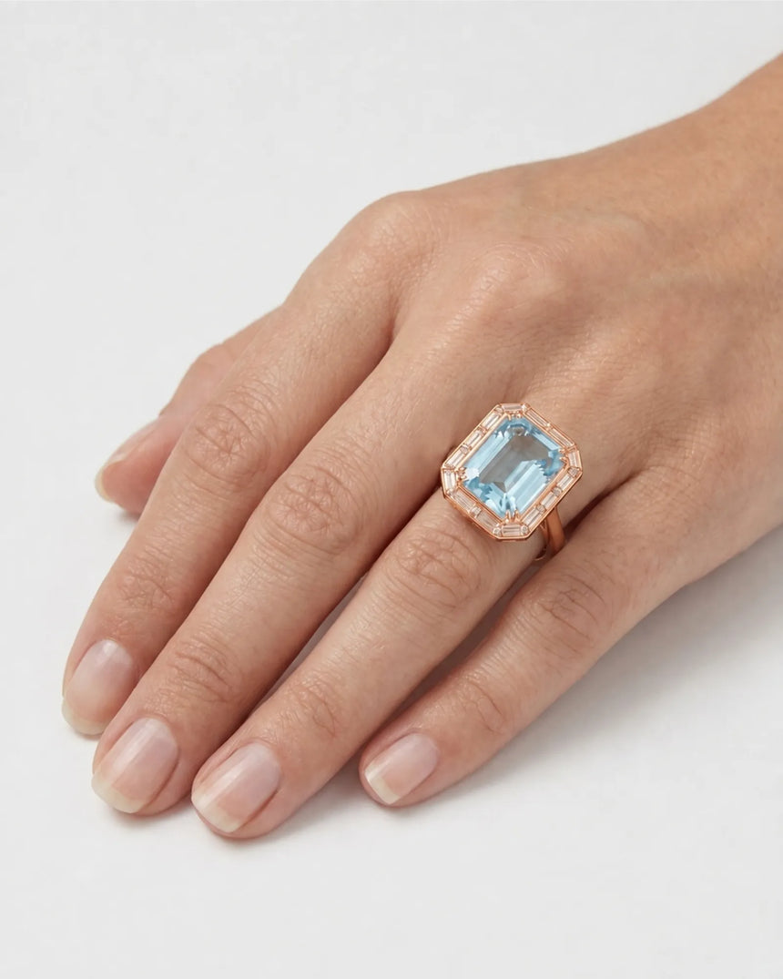 Lumière Octave emerald-cut Aquamarine baguette diamond halo ring setting in rose gold, worn on hand | SARATTI