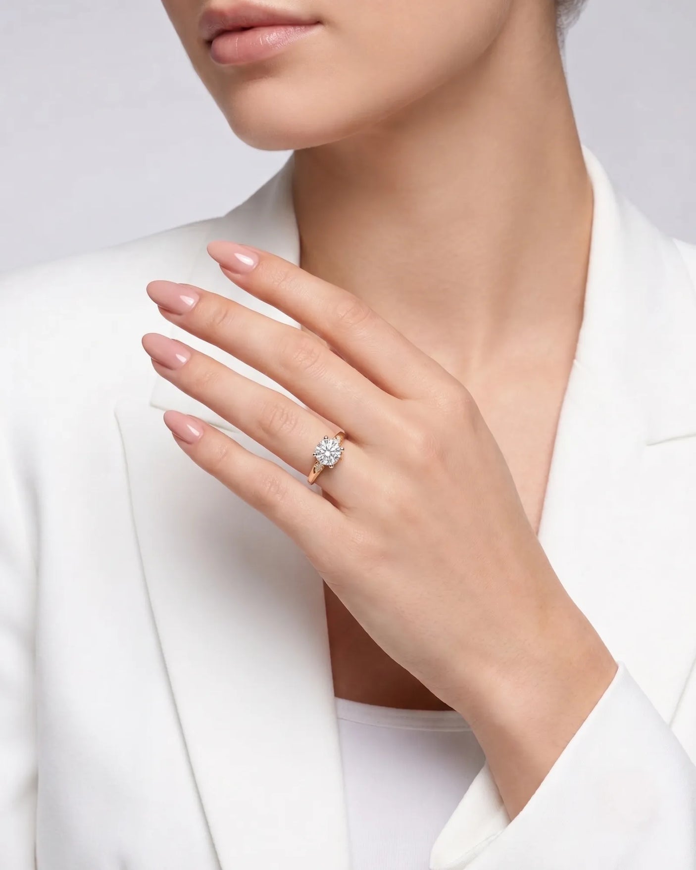 LUNA 1 carat round natural diamond four-prong engagement ring with natural diamond shoulders in 18K rose gold, worn on hand | SARATTI