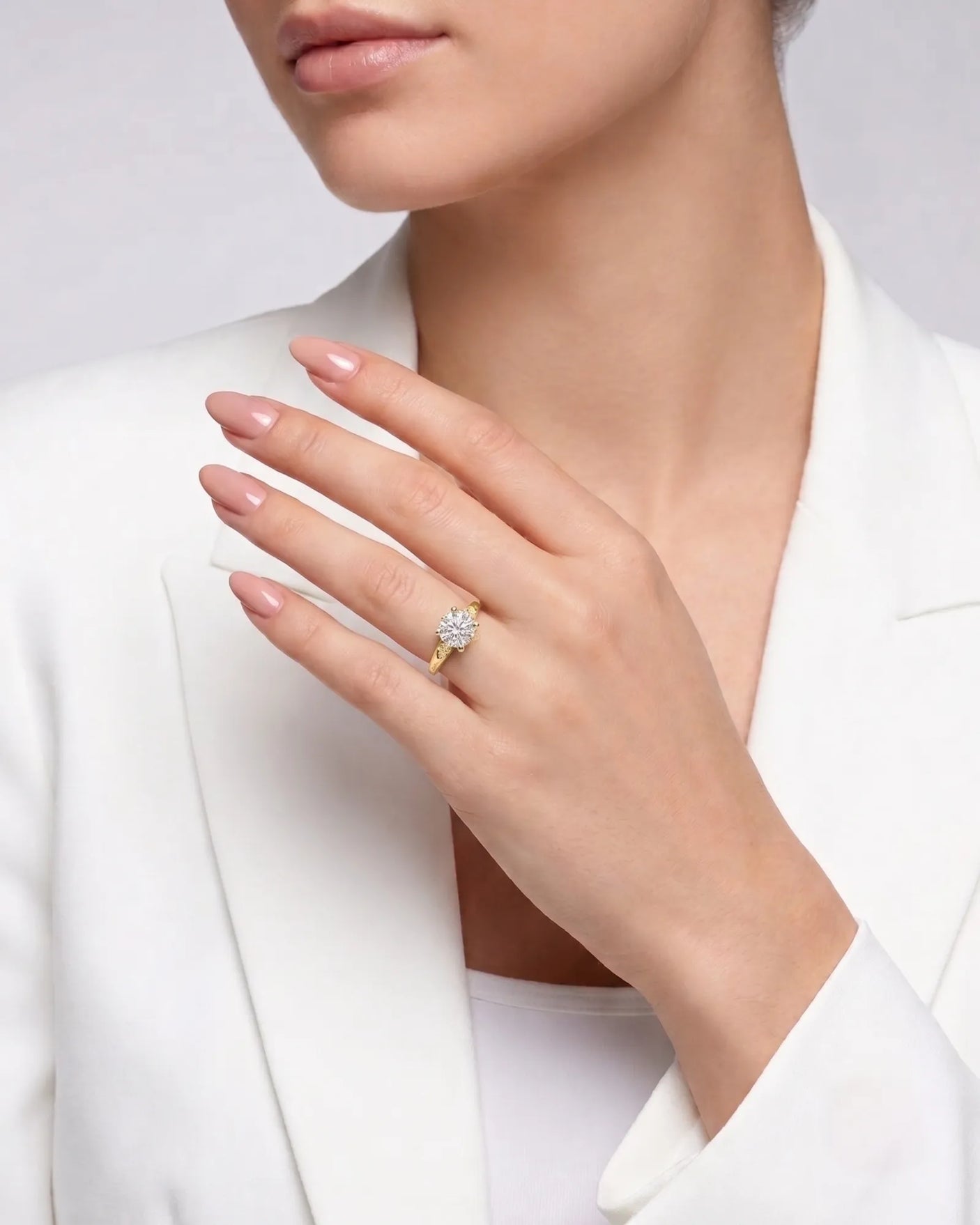 LUNA 1 carat round natural diamond four-prong engagement ring with natural diamond shoulders in 18K yellow gold, worn on hand | SARATTI