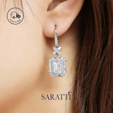 Emerald-cut halo earrings in platinum clarity | SARATTI