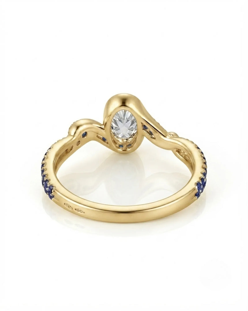 olorless oval moissanite framed by vivid blue sapphires in polished yellow gold | SARATTI