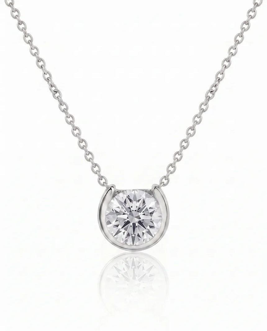Petite bezel round diamond solitaire necklace in Platinum, front view | SARATTI