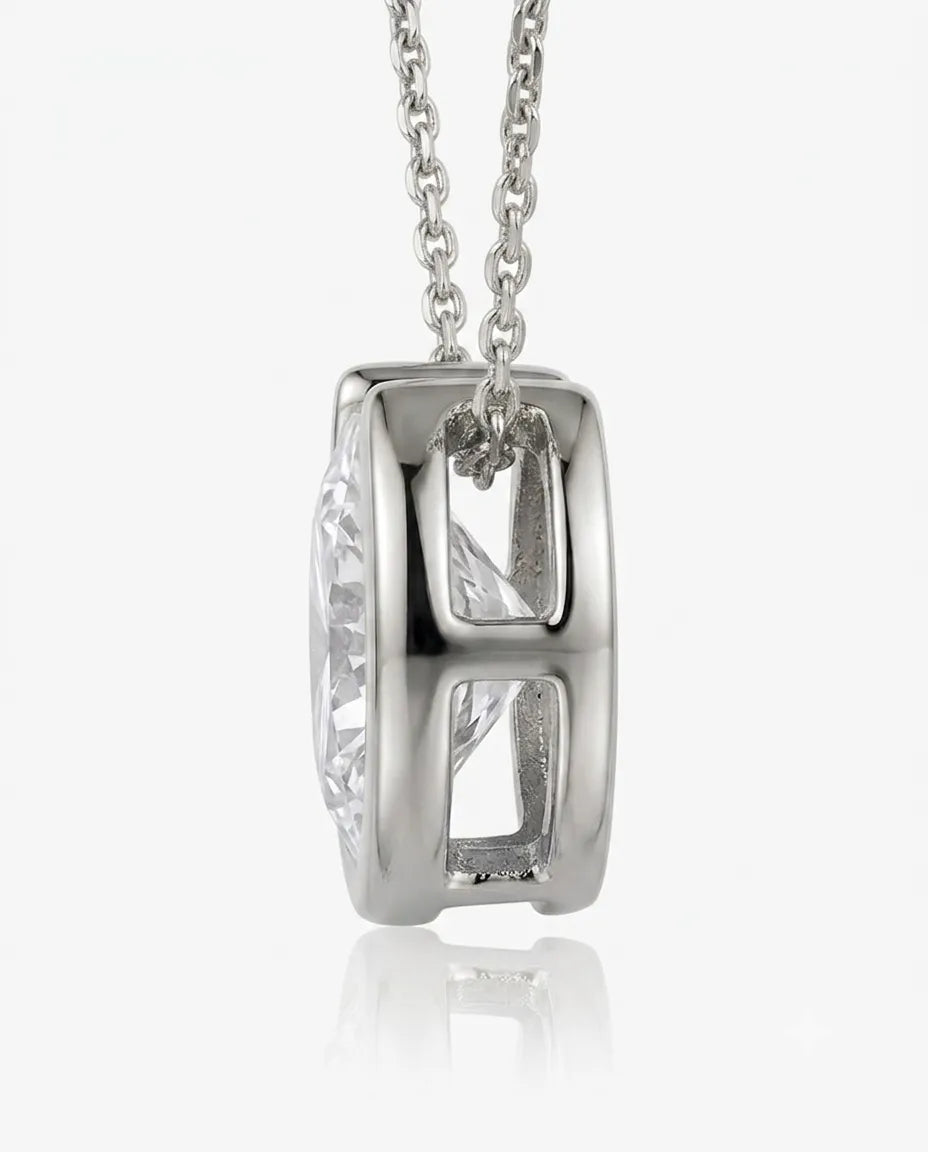 Platinum bezel diamond solitaire necklace, side profile view | SARATTI