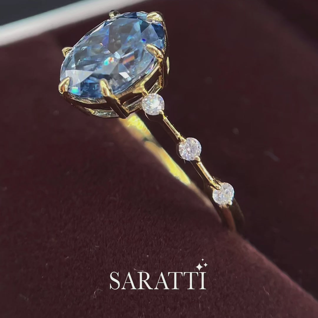 Luxury oval blue moissanite ring with accent stones and rich yellow gold finish - SARATTI