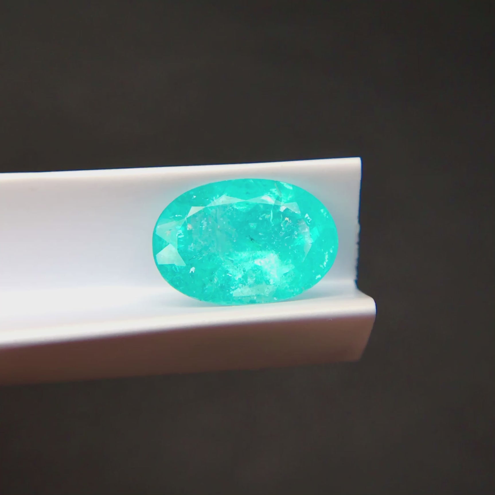 Natural Brazilian Paraiba Tourmaline oval loose gemstone side profile with dimensions 13.62 x 9.51 x 5.75 mm | SARATTI