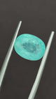 Natural Paraiba Tourmaline oval gemstone showing faceted surface reflections | SARATTI