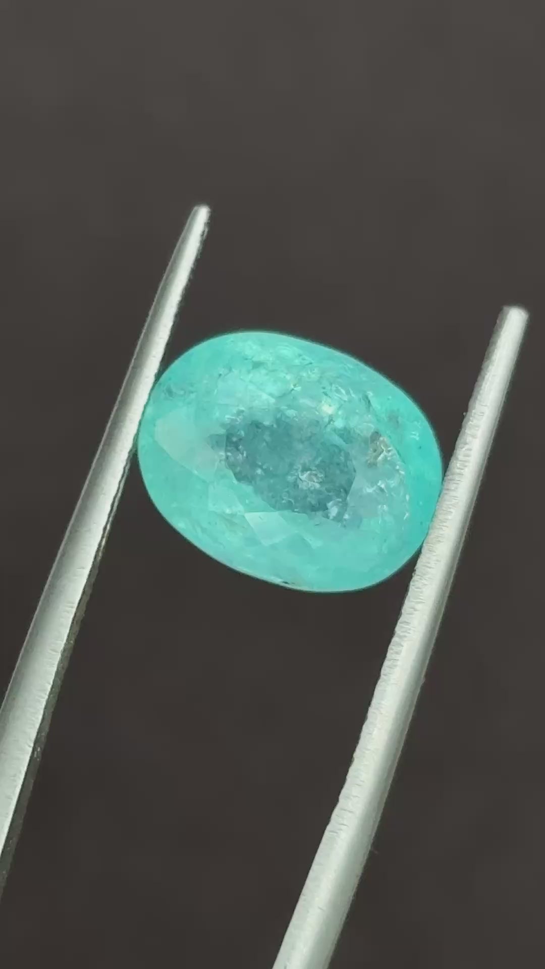 Natural Paraiba Tourmaline oval gemstone showing faceted surface reflections | SARATTI