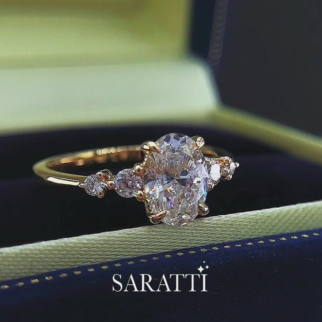 Luxury oval diamond ring with graduated side stones and bespoke 18K yellow gold craftsmanship | SARATTI