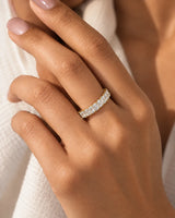 Radiant cut diamond eternity band in 18K yellow gold worn on model | SARATTI
