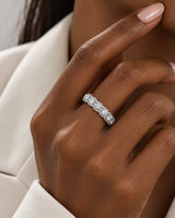 Round diamond cluster wedding band in 18K white gold worn on the hand | SARATTI