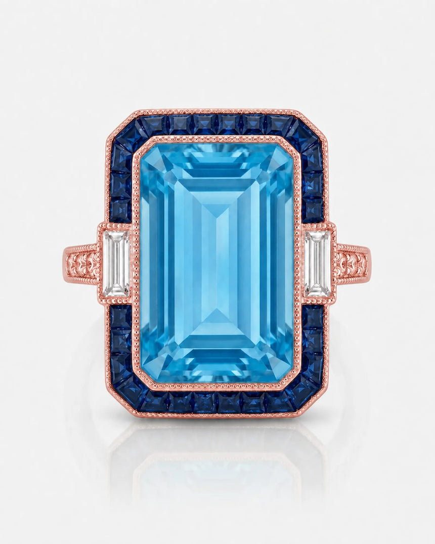 Saphira Line emerald-cut Aquamarine ring setting in rose gold, front view with blue sapphire halo and baguette side diamonds | SARATTI