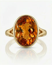yellow gold Imperial Topaz oval bezel ring with open shoulders | SARATTI