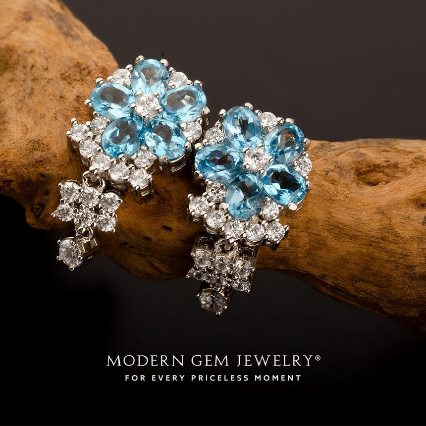 Prong set flower motif vintage style london blue topaz and diamond earrings 