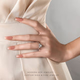 Model wears Illusion Set Three Stone Oval Engagement Ring 