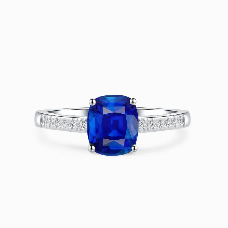 Cushion Cut Royal Blue Sapphire Ring against White Background - Sapphire Engagement Ring Settings and Styles for 2023 - Saratti