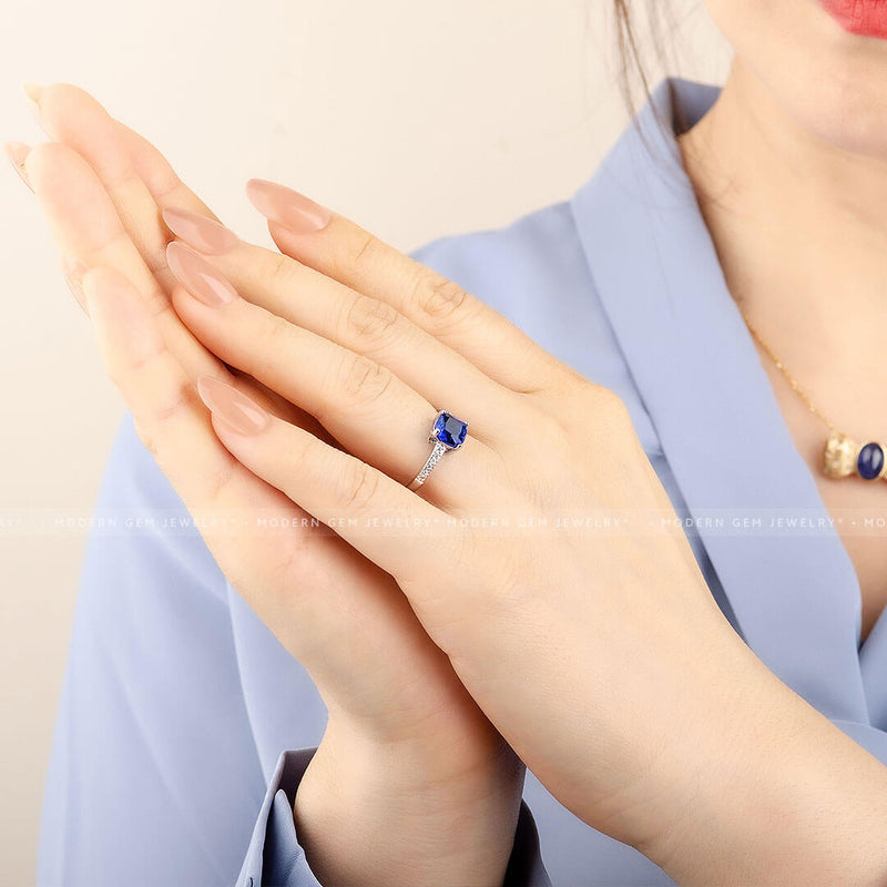 Cushion Cut Royal Blue Sapphire Ring on Model’s Finger - Sapphire Engagement Ring Settings and Styles for 2023 - Saratti