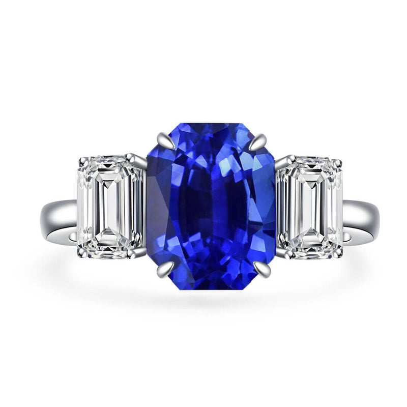 Beautiful Three Stone Emerald Cut Sapphire Ring against White Background - Sapphire Engagement Ring Settings and Styles for 2023 - Saratti