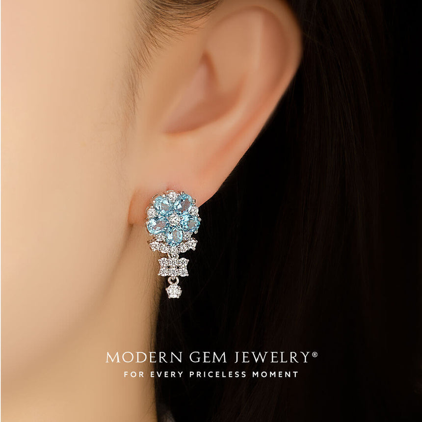 Model wears blue topaz white gold drop earrings 