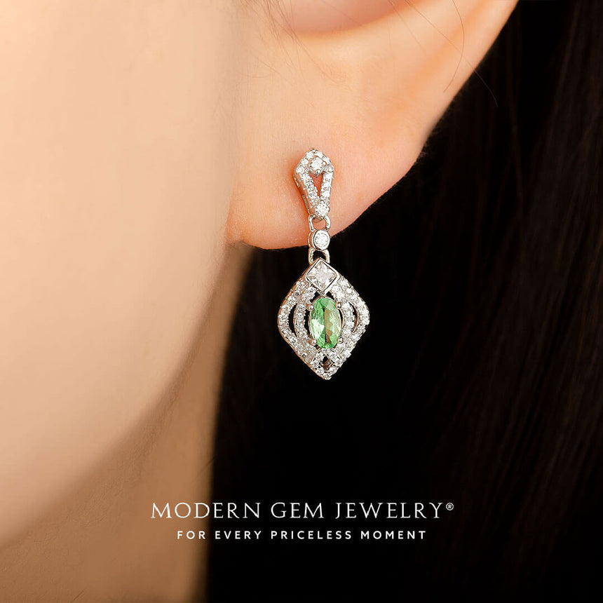 Model wears the green tsavorite and diamond drop earrings