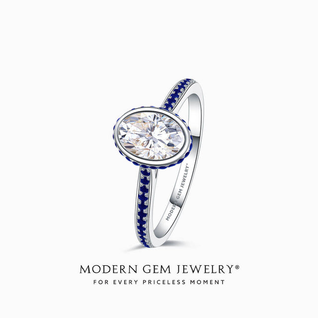 Oval Moissanite Ring with Blue Natural Sapphires in 18K White Gold Bezel Set | Modern Gem Jewelry