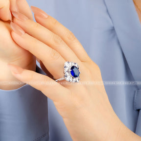 Oval Royal Blue Cocktail Ring with Sapphire and Diamond Accent Stones in 18K White Gold on Woman's Hand Side Shot | Saratti