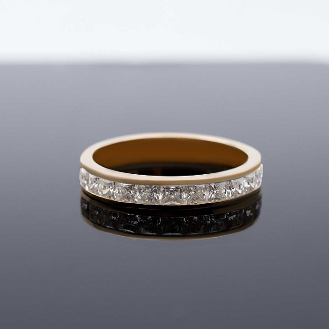 Princess Cut Diamond Wedding Band in Yellow Gold against Black Matte Background| Modern Gem Jewelry | Saratti 